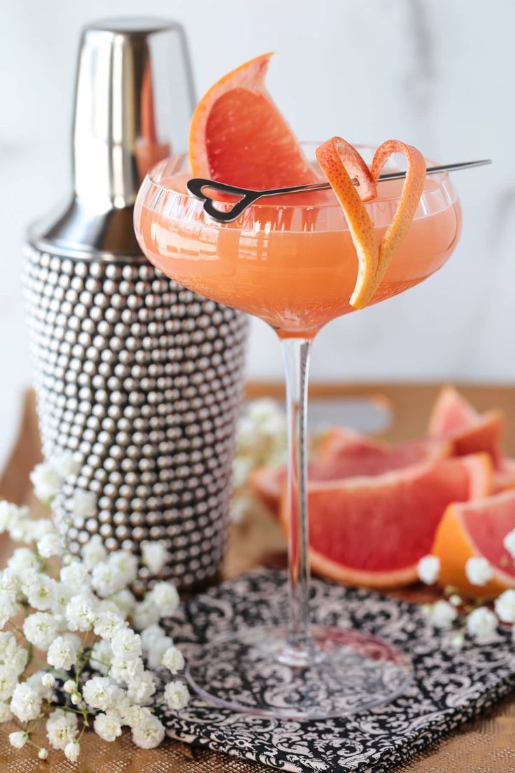 a grapefruit cocktail garnished with an orange slice