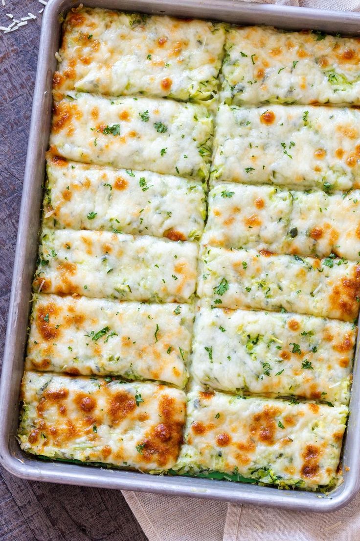 a casserole dish with cheese and broccoli in it on a napkin