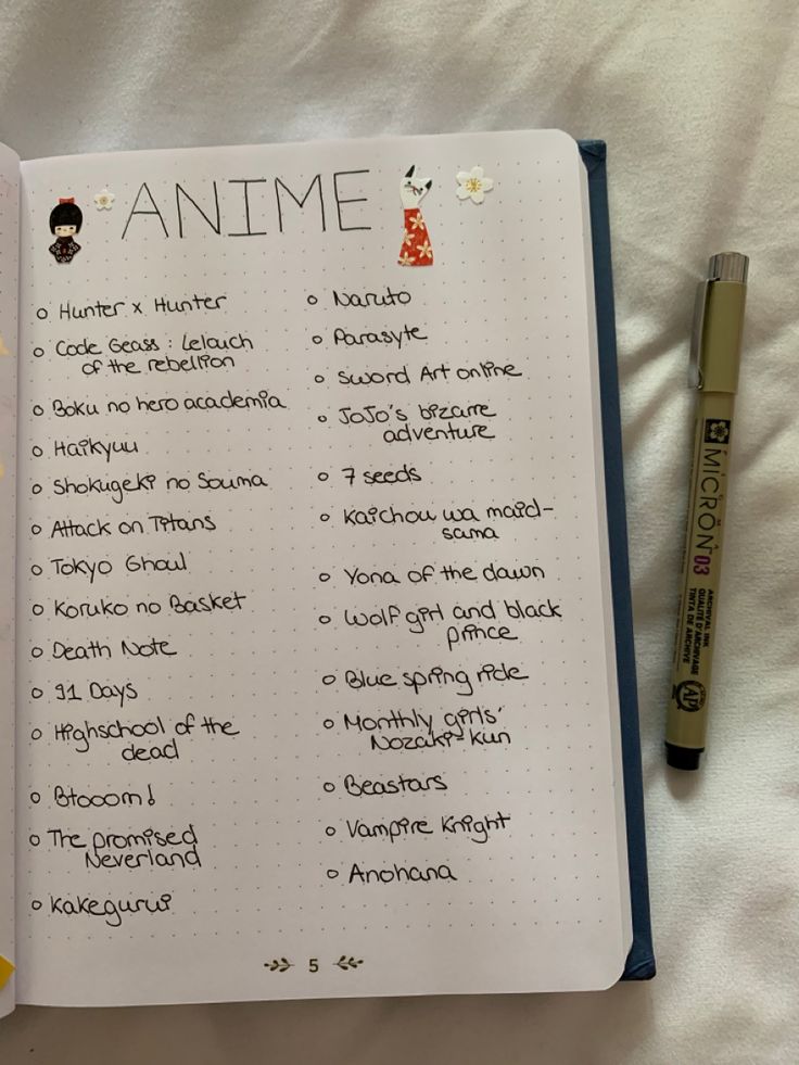 an open notebook with some writing on it next to a marker and pen, which is also labeled anime