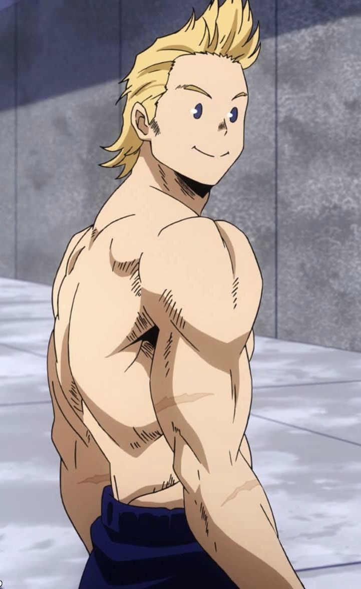 a man with blonde hair and no shirt on standing in front of a stone wall