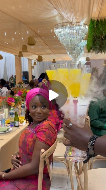 a man and woman sitting at a table with drinks