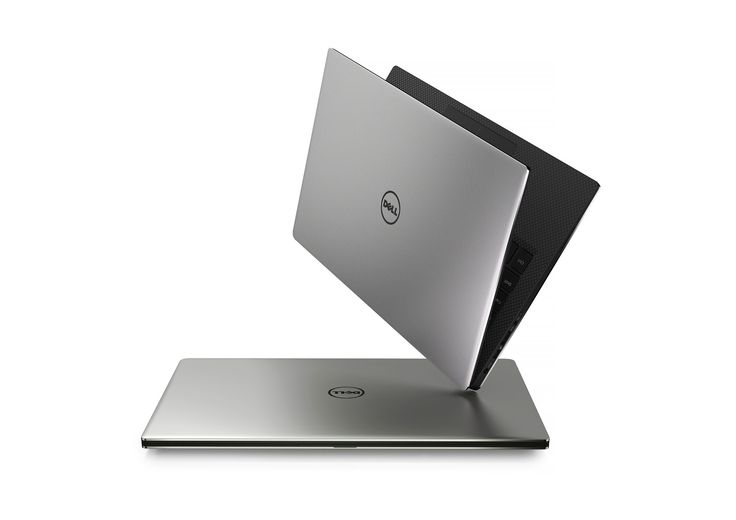 an open laptop computer sitting on top of a white surface