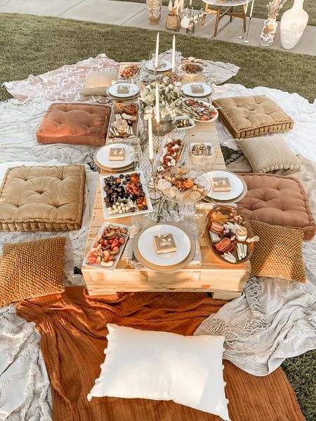 a table set up for a party with plates and napkins on top of it