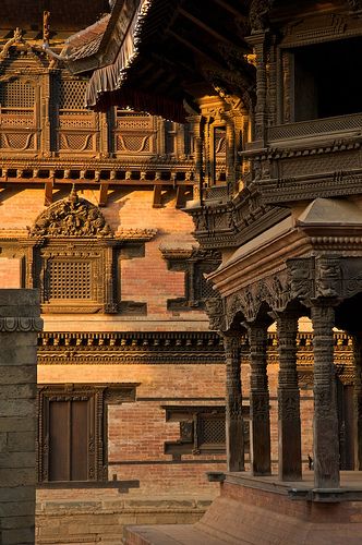 an intricately carved building with pillars and windows