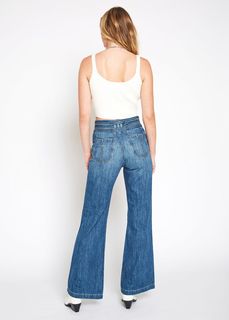 Belted high rise wide leg with fashion pocket and waistband. It is made from classic rigid denim in our bestselling classic blue wash with light fading and whiskering elements. Model is 5'10" wearing size 26. Approx. Rise: 13" Inseam: 33"Approx. Knee: 19 1/2" Leg Opening: 22" 100% Cotton Made in USA Fits true to size. Wide-leg Washed Blue Jeans With Pockets, Washed Blue Wide-leg Jeans With Pockets, Relaxed Fit Wide-leg Jeans With Welt Pockets, Mid-rise Rigid Denim Jeans With Side Pockets, Mid-rise Rigid Denim Flare Jeans With Five Pockets, Odessa, Classic Blue, Independent Designers Fashion, Bell Bottom Jeans