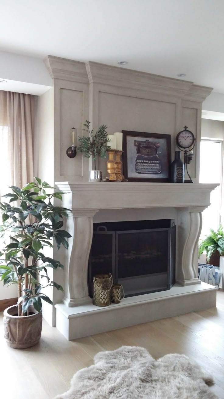 a living room with a fireplace and potted plants on top of the mantel