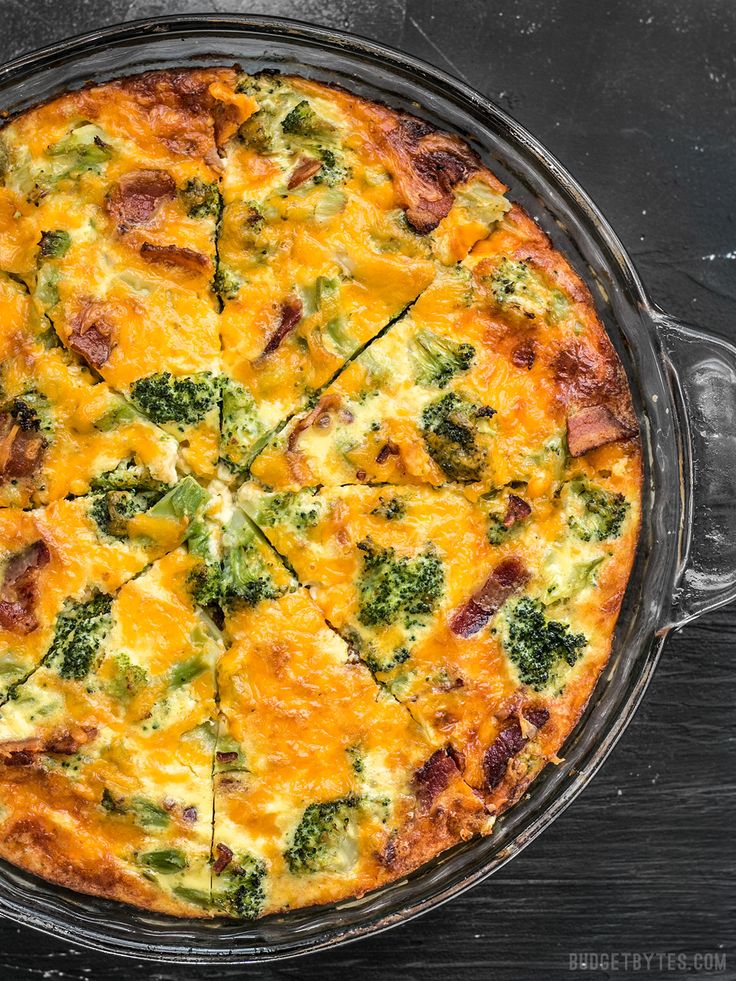 a cheesy dish with broccoli and other toppings in a pan