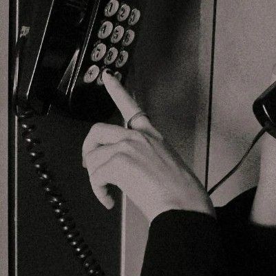 black and white photograph of a person using a telephone