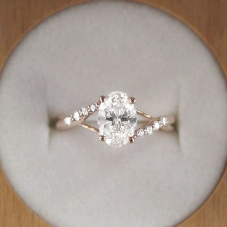 an engagement ring is displayed on a white plate