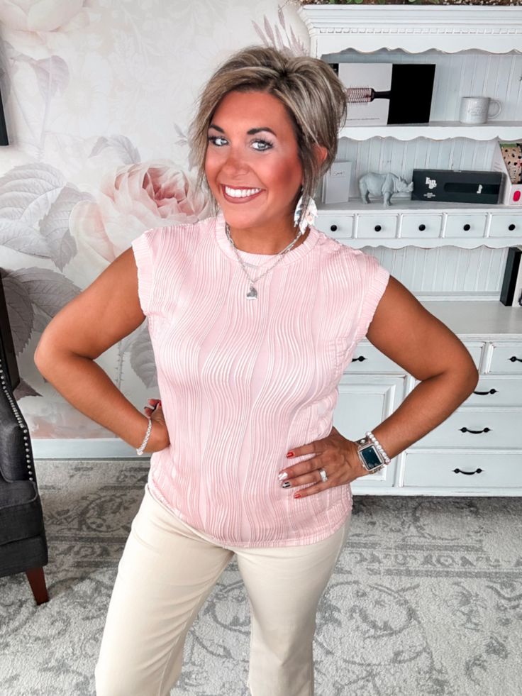 This sassy top is all about making a statement. With an ultra-flirty wavy texture, cap sleeves, and a curve-hugging round neckline, the Look What You've Done top lets your playful style shine through. Whether you're heading out for a night on the town or keeping it casual, this top adds instant fun and flair to any look. The lightweight, breathable poly blend keeps you cool and comfortable while giving this piece its signature flowy, textured feel. Pair it with your favorite distressed jeans or Summer Feminine Textured Tops, Feminine Textured Summer Tops, Textured Feminine Summer Tops, Chic Short Sleeve Textured Tops, Chic Textured Short Sleeve Tops, Textured Stretch Sleeveless Tops, Trendy Textured Short Sleeve Tops, Textured Fitted Short Sleeve Top, Trendy Textured Tops