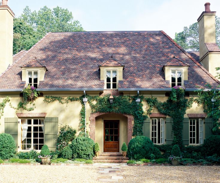 a house with ivy growing all over it's walls and windows on the front