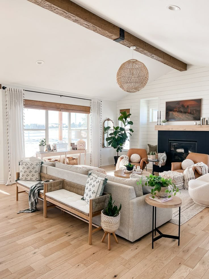 a living room filled with furniture and a fire place in the middle of a room