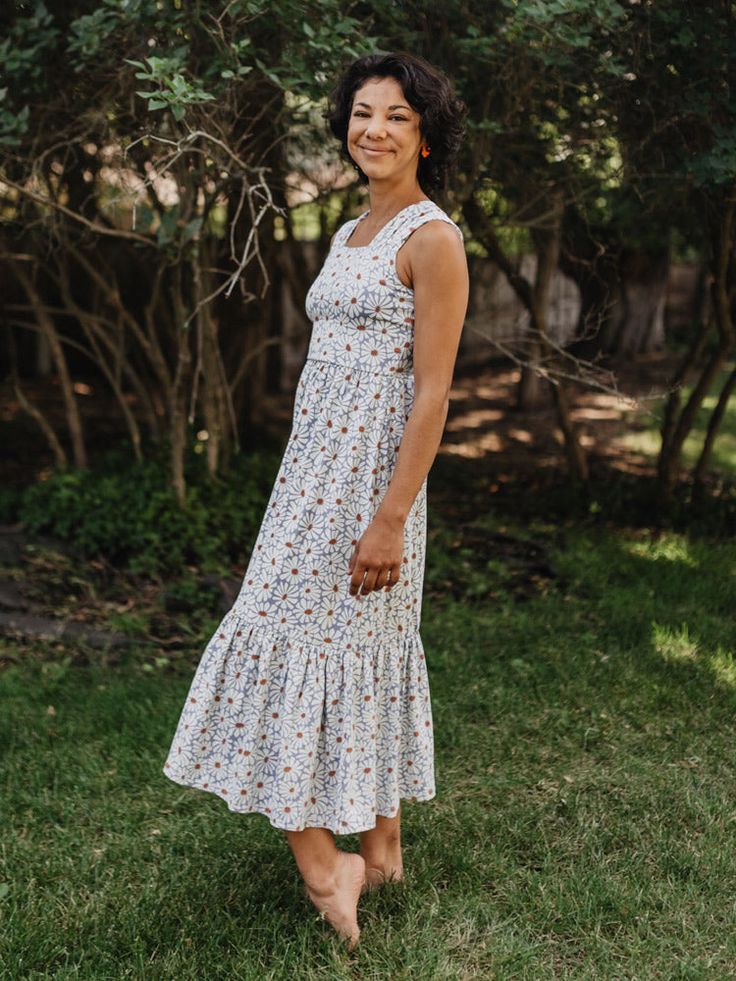 Our soft and stretchy organic cotton jersey is the perfect fabric for this midi dress. With a soft floral print, chic tiered hem, and feel-good wide straps, it's a dress that can go all day and carry you right into the evening. Jersey. 95% Organic Cotton 5% Spandex Length of size M is 42" from top of bodice Made fair trade in India by one of our longstanding production partners Midi Length Sundress With Ruffle Hem For Daywear, Casual Floral Tiered Skirt Dress For Garden Party, Casual Floral Tiered Dress For Garden Party, Cotton Midi Dress With Ruffle Hem For Garden Party, Casual Sleeveless Midi Dress With Ditsy Floral Print, Casual Tiered Dress With Ruffled Straps For Garden Party, Casual Sundress With Ruffle Hem And Square Neck, Sleeveless Cotton Tiered Dress For Daywear, Cotton Midi Sundress For Garden Party