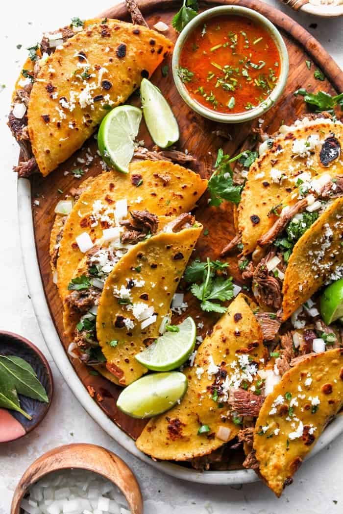 mexican food is served on a platter with salsa and tortillas