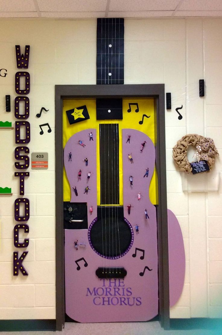 a purple guitar shaped door with musical notes on the front and side panels above it