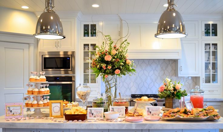 a kitchen filled with lots of food on top of a counter