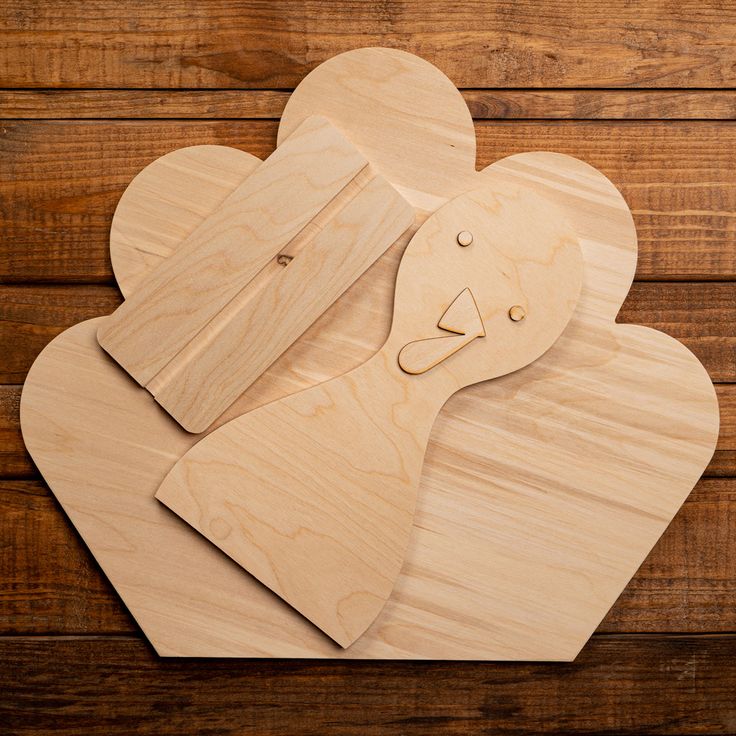 two wooden mouses on top of each other with faces carved into the shape of hearts