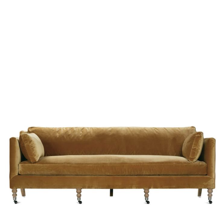 a brown couch with two pillows on it's back and one arm extended to the side