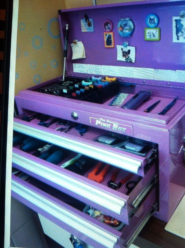 an old fashioned purple cash register with lots of drawers and items on it's sides