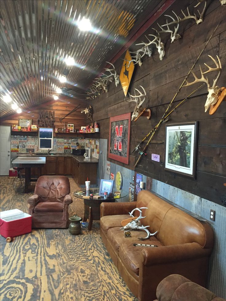 a living room filled with furniture and antlers on the wall