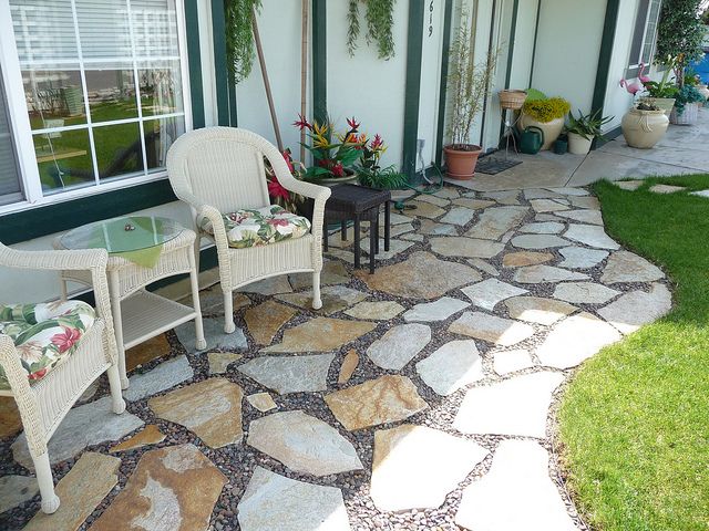 a patio with two chairs and a table