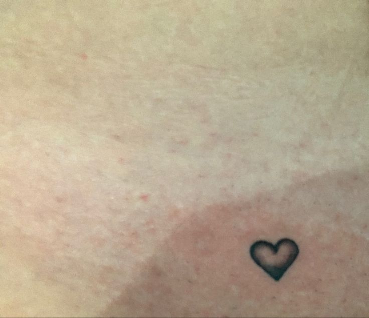 a small heart tattoo on the chest