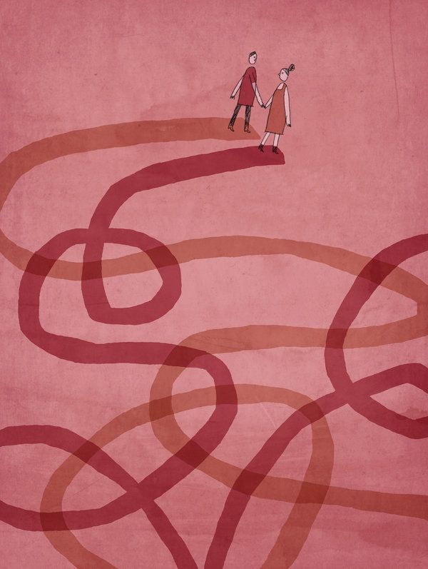 two people walking across a red carpet with an intertwined design on it's side