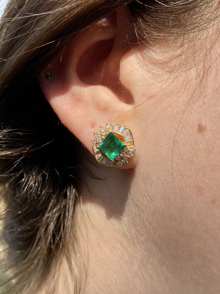 "Pacific Jewelry Presents, Vintage natural Colombian Emeralds, featuring two exquisite square cut Emeralds weighing approx. 1.70 carats (total) and adorned with lively colorless natural diamonds. Diamonds are an assortment of baguette and round cut, approx. 1.35 carats (total). These beautiful earrings are mounted in 18k yellow gold, and have a safe push back closure made in 14k gold for extra strength and durability. The Emeralds are of the highest quality and are untreated. The deep \"muzo gre Luxury Yellow Gold Cluster Earrings With Gemstones, Elegant Gemstone Baguette-cut Earrings, Luxury Gia Certified Yellow Gold Earrings, Gia Certified Luxury Yellow Gold Earrings, Gia Certified Classic Evening Jewelry, Formal Yellow Gold Gia Certified Diamond Earrings, Formal Gia Certified Yellow Gold Diamond Earrings, Gia Certified Yellow Gold Diamond Earrings For Formal Occasions, Luxury Gia Certified Yellow Gold Diamond Earrings