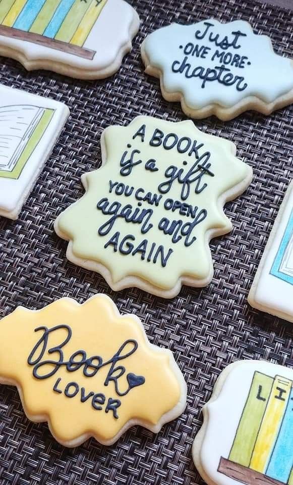 decorated cookies with writing on them sitting on a table