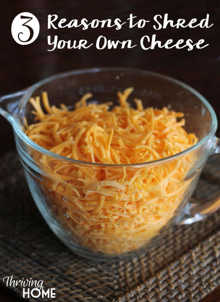 shredded cheese in a glass bowl with the words 5 reasons to shred your own cheese