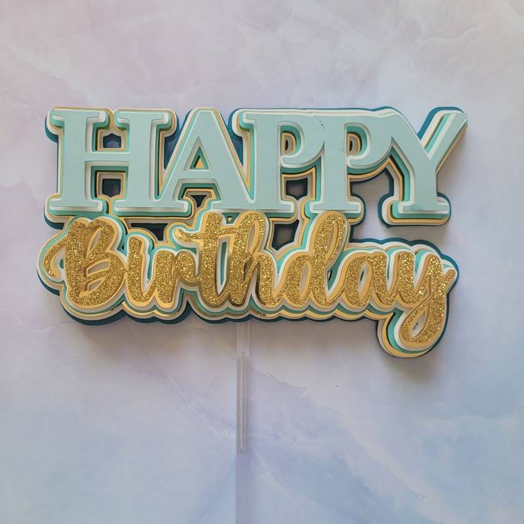 a happy birthday cake topper with the words happy birthday on it's side