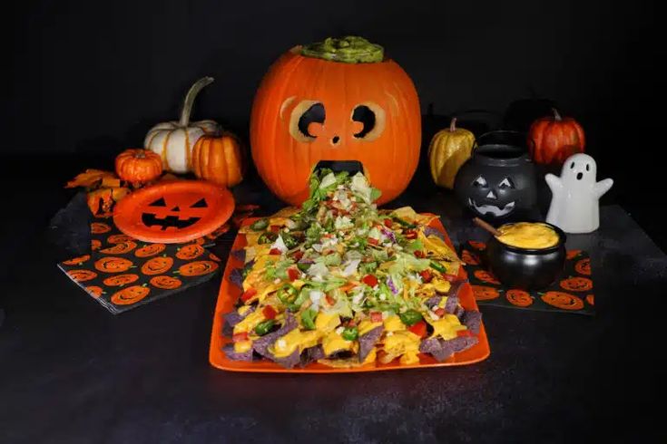 an orange plate topped with salad next to halloween decorations