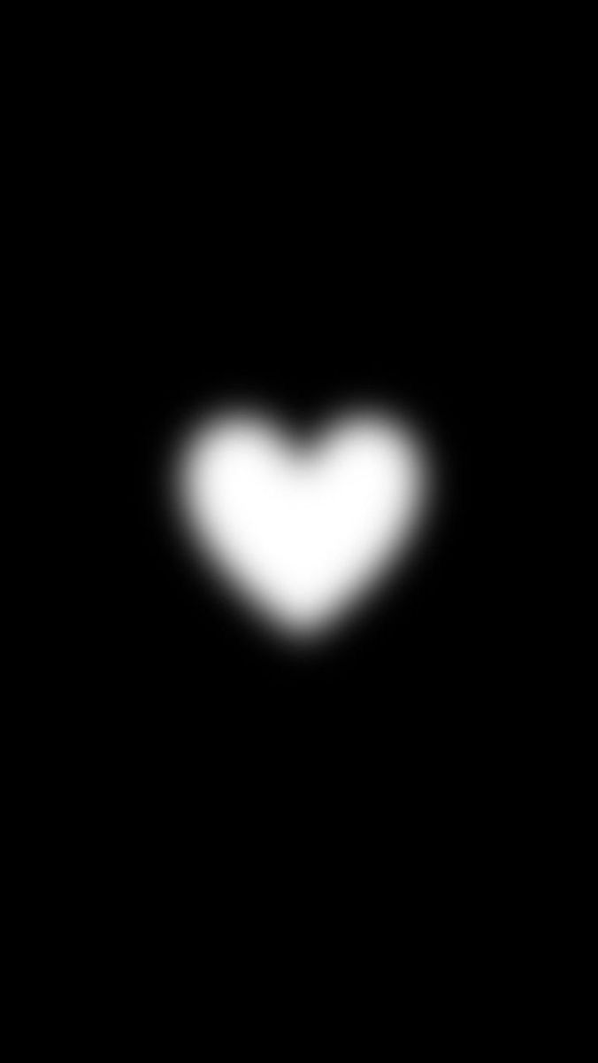 a heart shaped object is seen in the dark