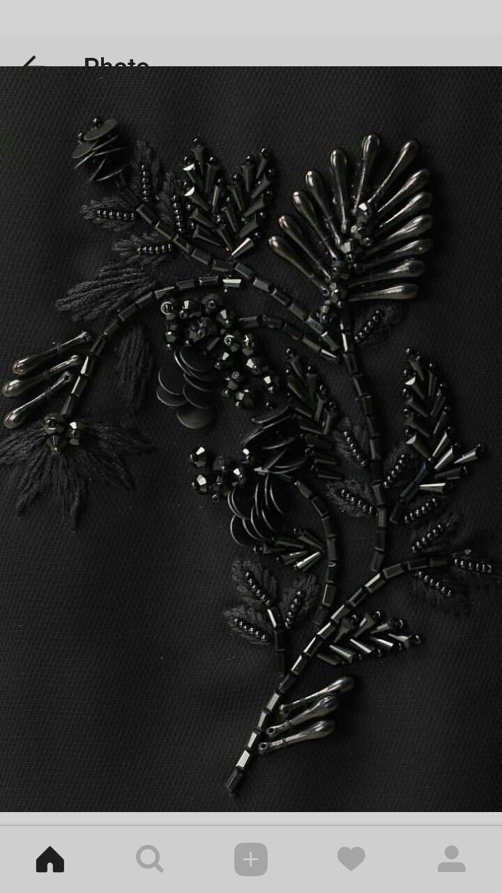 an image of some sort of brooch on a black background with other things in it