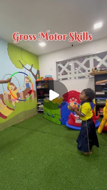 two children playing with toys in a play area at the gross motor skills center, which is open for business