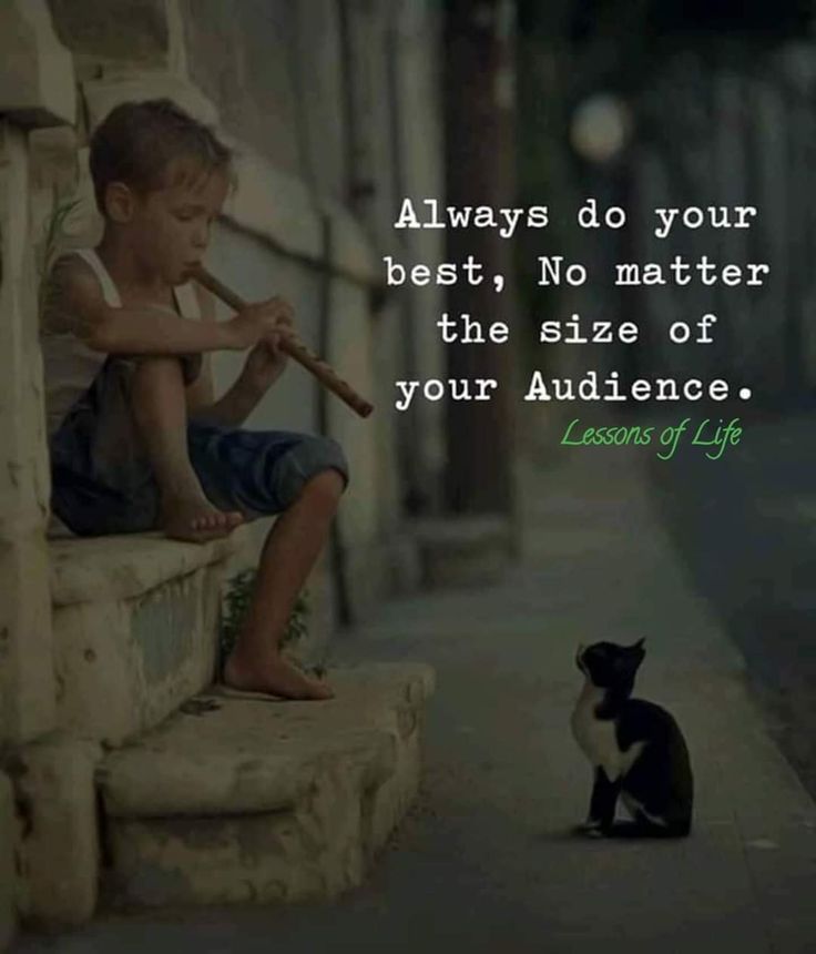 a little boy sitting on a bench with a bat in his hand next to a black and white cat