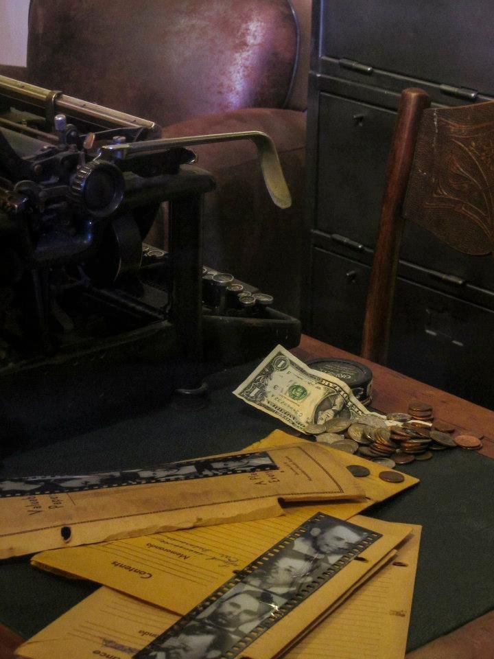 an old fashioned typewriter sitting on top of a table next to papers and money