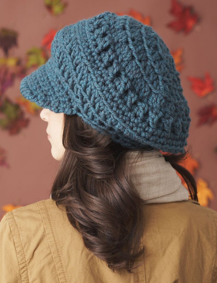 a woman wearing a blue crocheted hat