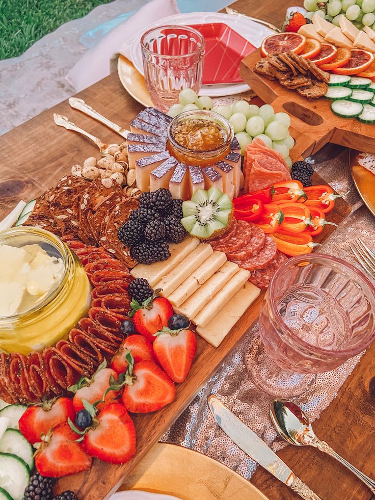 a wooden table topped with lots of different foods and desserts on top of it