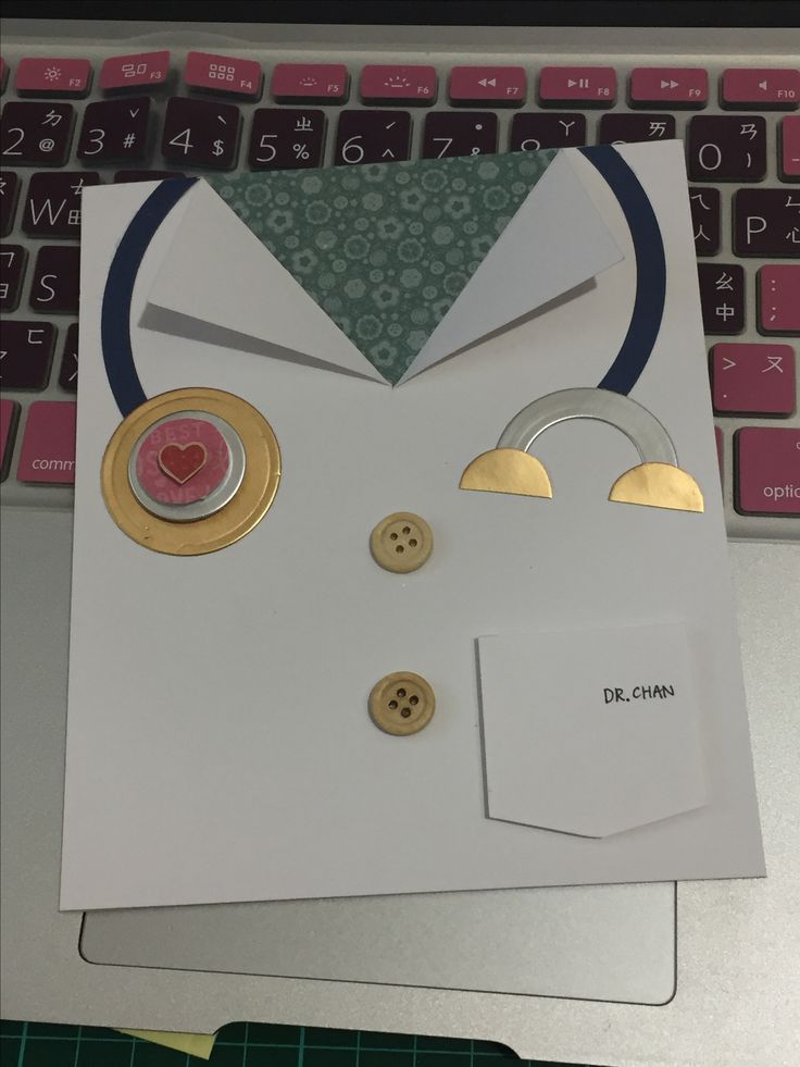 a cat shaped card with buttons on the front and back of it, next to a computer keyboard