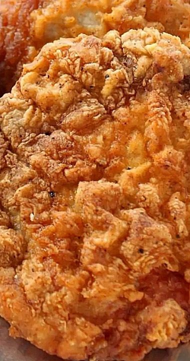 two fried food items sitting on top of a piece of paper