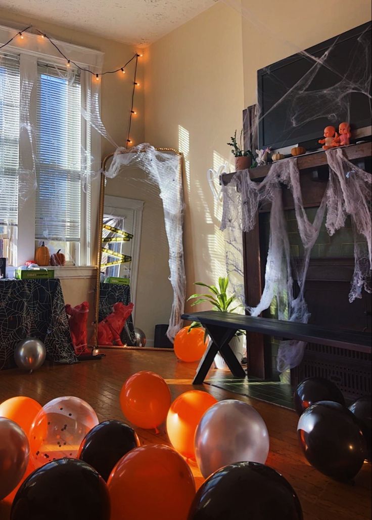 halloween decorations and balloons on the floor in a living room