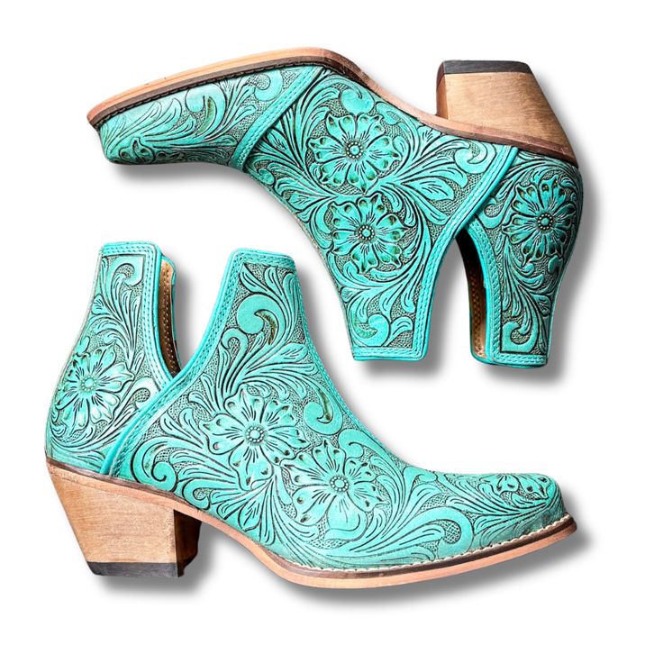 Step into the epitome of Southwestern flair with these Western leather booties, meticulously hand-tooled to highlight a stunning blend of rich deep teal and ebony. Featuring classic cowboy heels and convenient side slits, they blend traditional craftsmanship with modern ease. The intricate design, showcasing a pattern of desert blossoms, adds a distinctive touch of elegance. Ideal for transforming any ensemble, these tooled boots exude statement-making style with every step. 2-2.5" slanted heel. Tooled Boots, Cowboy Heels, Swim Belts, Hay Bag, Classic Cowboy, Wrap Boots, Silver Jewelry Box, Horse Boots, Dog Collars & Leashes