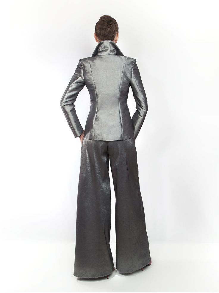 Our EXCLUSIVE limited edition. Dark silver semi stretch taffeta ladies pantsuit. Made exclusively to order in house. Introducing my latest obsession: a made-to-measure, dark-silver pantsuit that’s perfect for summer days at the office! ☀️ This sexy and feminine silhouette features strong shoulders and a stand-up collar, making a bold statement while keeping me comfortable all day long. 💃 Plus, it’s wrinkle-free, easy to care for, and incredibly flattering! 🌟 Say goodbye to wardrobe dilemmas and hello to effortless style with this must-have piece. CARE: Dry clean only TURNOUROUND TIME: 14 - 19 business days processing + shipping via USPS. You can choose express USPS express shipping as well. Contact us if you need to hurry. +++++++++++++++++++++++ Size Guide https://mologokocouture.com/pa Elegant Silver Party Pants, Elegant Silver Pants For Evening, Fitted Satin Pantsuit For Workwear, Elegant Fitted Silver Bottoms, Silver Elegant Evening Bottoms, Metallic Fitted Pants For Formal Occasions, Silver Fitted Bottoms For Formal Occasions, Elegant Fitted Silver Pants, Elegant Fitted Metallic Bottoms