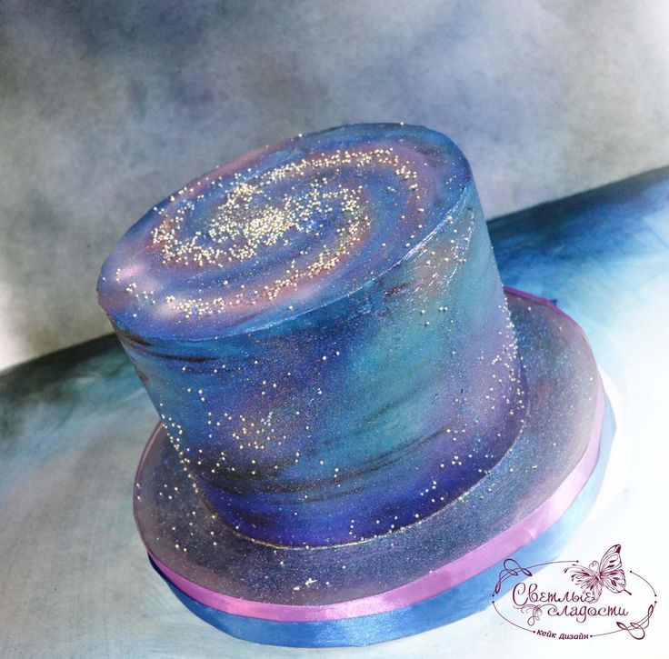 a blue and purple hat with gold glitters on it's top sitting on a table