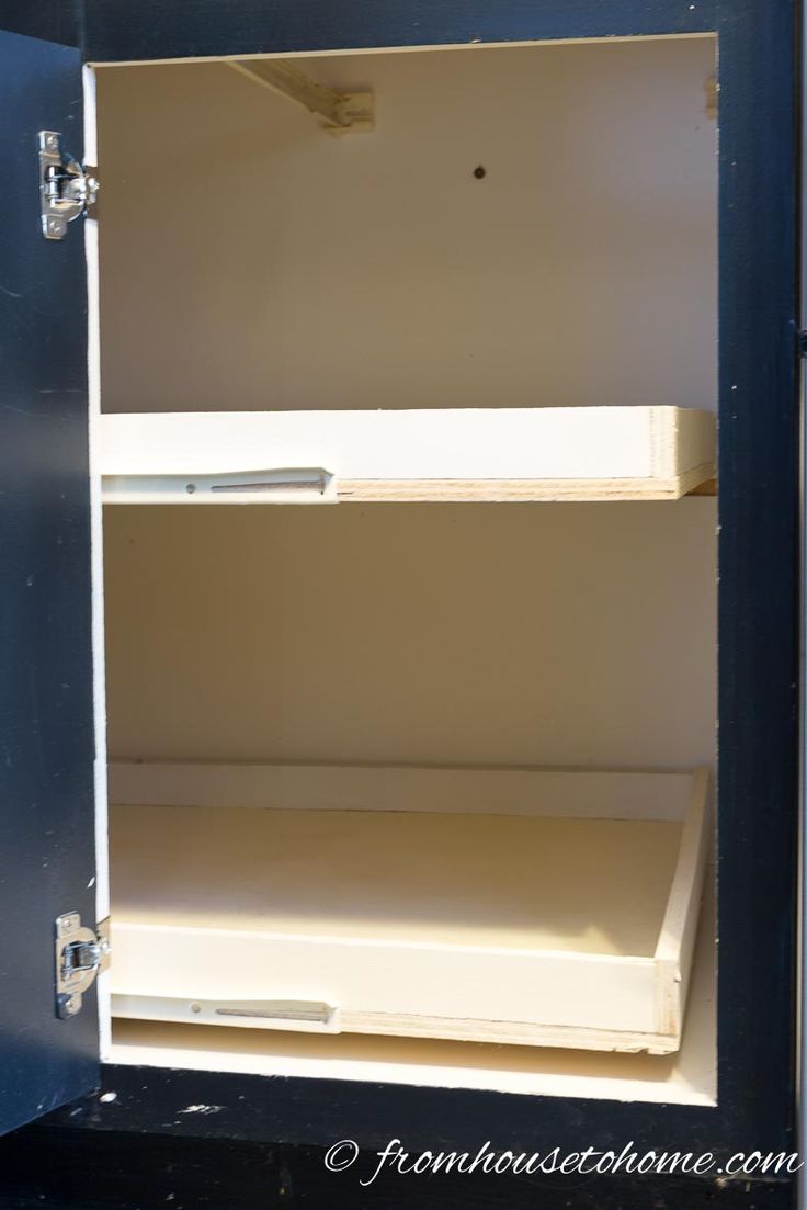 an open metal box with two shelves in it