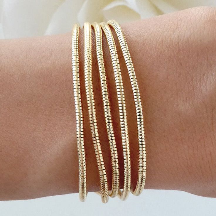 Attached layers Includes everything pictured Material: gold plated brass Length: 7" + 2" extension Gold Multi-strand Stackable Bracelets, Gold Metal Bracelets For Layering, Gold Flexible Snake Chain Bracelet, Gold Brass Stackable Bracelets, Gold Stackable Brass Bracelets, Adjustable Gold Bracelet For Layering, Adjustable Gold Snake Chain Bracelet, Gold Multi-strand Stackable Jewelry, Gold Plated Flexible Chain Bracelet