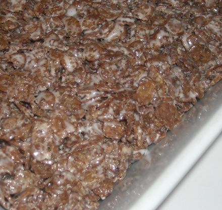 a close up view of some food on a tray with icing and brown sugar