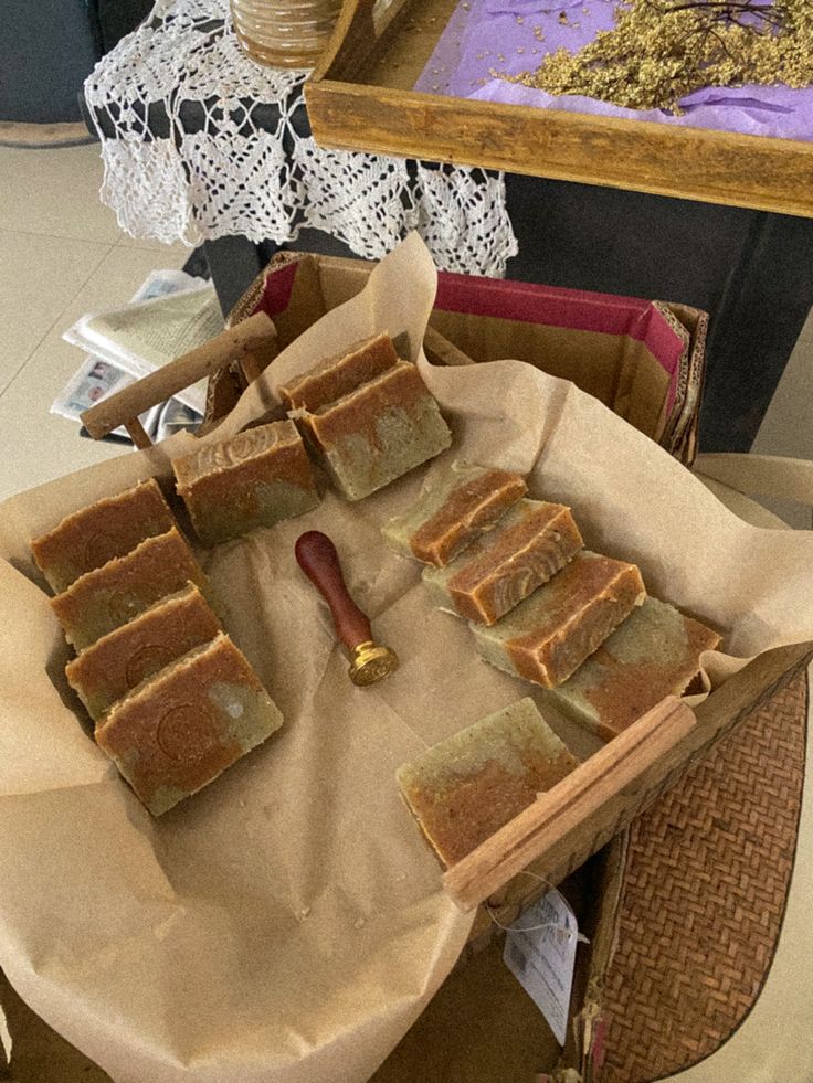 several pieces of cake sitting on top of a table next to a tray with pastries