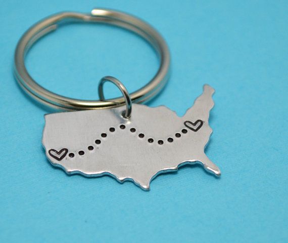 a metal keychain with a heart in the shape of the state of indiana